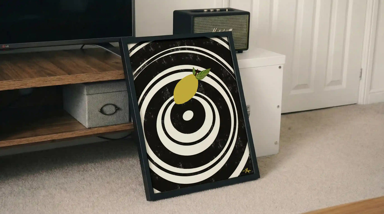 Framed lemon wall art with black-and-white bullseye target and yellow lemon illustration